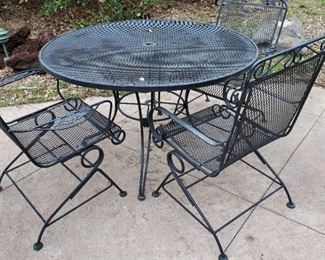 Metal table, three rocking highback chairs