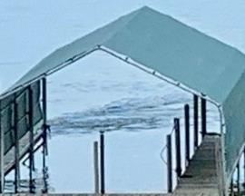 2018 Forest Green Dock Cover. Measuring approximately 30 feet long by 12 feet wide. The roof, side poles and white bumpers are included.  This item is in very good/used condition. It is not set up. It was stored over the winter. This quality item retails for about $8,000. 
