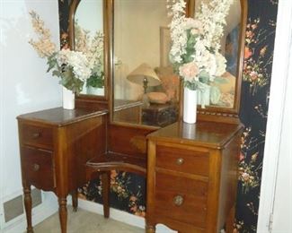 antique vanity with a threefold mirror
