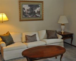 Floor lamp, white/ivory sofa (93.5” long, 27” high, 34” deep), end table, drop leaf coffee table (52”x18”, 52”x36” w/leaves up).