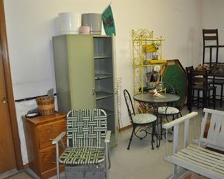 Oak 2-drawer file, vintage aluminum chair w/woven straps, mid-century olive green metal cabinet, wrought iron folding round table w/2 chairs, Whalen pub table w/4 chairs (38” square, 36” high), wooden glider (49” wide, 26” deep).