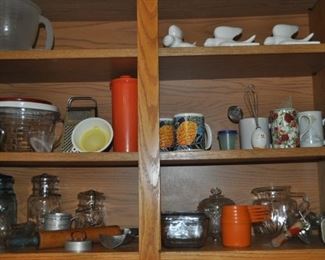Vintage kitchen items: ball jars, Tupperware, Depression glass, pitcher, egg beater, rolling pin.  Mugs, funnels, measuring cups.
