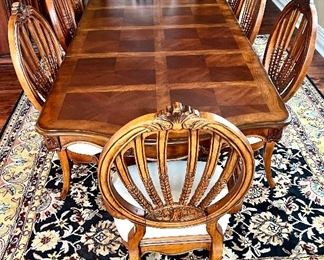 Statement Dining Room Table & Eight Chairs. This table is crafted in a beautiful timeless, classic design. It truly has a gorgeous appearance. 

The set includes eight chairs, two of which are host chairs. 

The table as shown has two leaves inserted and measures 106" x 44" x 30" (the two inserted leaves each measure 18"). With no leaves inserted, the table would measure at 70" x 44".  The table is in overall good condition with some light wear.