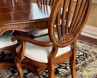 Statement Dining Room Table & Eight Chairs. This table is crafted in a beautiful timeless, classic design. It truly has a gorgeous appearance. 

The set includes eight chairs, two of which are host chairs. 

The table as shown has two leaves inserted and measures 106" x 44" x 30" (the two inserted leaves each measure 18"). With no leaves inserted, the table would measure at 70" x 44".  The table is in overall good condition with some light wear.