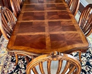 Statement Dining Room Table & Eight Chairs. This table is crafted in a beautiful timeless, classic design. It truly has a gorgeous appearance. 

The set includes eight chairs, two of which are host chairs. 

The table as shown has two leaves inserted and measures 106" x 44" x 30" (the two inserted leaves each measure 18"). With no leaves inserted, the table would measure at 70" x 44".  The table is in overall good condition with some light wear.