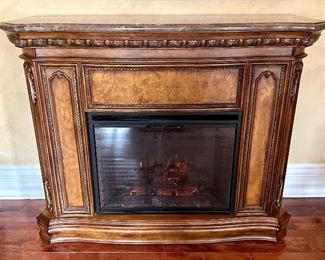 Decorative Electric Fireplace with marble top. Manufactured by Twin Star. Tested and works. Features varying degrees of temperature control. Just use the flames for beautiful ambience or heat up the room on a chilly day!  

Model no 28EF004GRS. 

Does have a crack in the corner on the top which is shown in the photographs