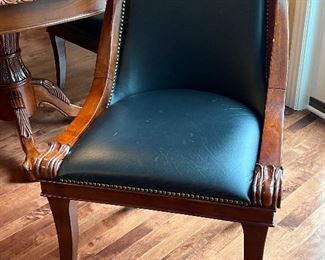 Pedestal Kitchen Table and Five Chairs measuring 54" in diameter and 31" high. The table has a lovely pedestal design featuring decorative clawed feet. The table has some wear to the finish including a single small hole drilled in the center of the table and some small dings. The chairs have some wear including scratch marks on the seats