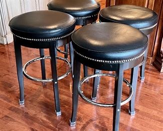 Set of Four Barstools in good/used condition with some wear including some scrape marks on the faux leather seats and some of the nail head trim may be missing. The seats are a generous size at 19.5" in diameter. Barstool height is 29" h . 