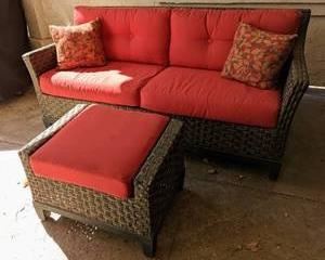 Grey Rattan Outdoor Sofa and Ottoman. This item matches the next few lots. There is some wear/stain on the cushions that can be seen in the photos. The sofa measures 70” wide, 26” deep, 21” high to the seat and 34” high to the sofa back