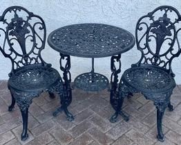 Wrought Iron Table and Chairs of which the table measures 26 inches tall and is 25 inches in diameter
