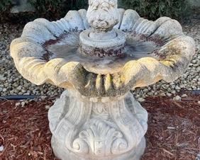 This cement bird bath measures 28 inches tall. There is some wear and this can be seen in the photos.