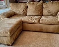 This microsuede sofa sleep measures 85x36x34 inches and is accompanied by a matching ottoman. These items are in good condition with some light wear including a stain on the ottoman 