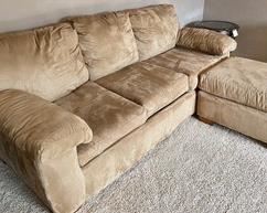 Microsuede Sofa Sleeper with Ottoman. The sofa measures 85x36x34 inches. In used condition with some wear including some slight stains on the ottoman and on the side of one cushion. 