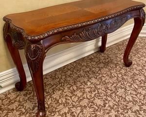 This lovely console table measures 50x20x31 inches. Beautifully carved table providing a classic, timeless look. Lovely carved design accented with curving legs. Sure to add style and grace to any room in your home. 
