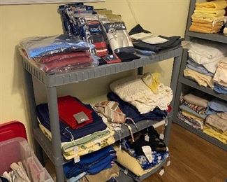 Linens and top shelf has new mens clothing 