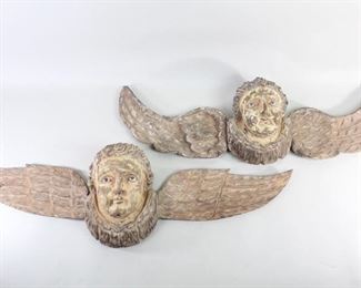 Lot 28: Pair of Carved Angel Cherub Head Wall Plaque Sculptures. Two carved wooden angels with long, extended wings and glass eyes. Roughly carved, yet with fine details and expressive faces. Mostly stripped of previous paint, though some still remaining, which adds to their character. Great patina throughout. Acquired in the 1980s, Philippines. From the collection of Barbara Porter & Robert Wincuinas.

Dimensions are 11 in h x 34 in w x 6 in d. Condition is good. Please call or email for a detailed condition report.