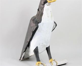 Lot 38: American Folk Art Mixed Media Penguin on Log Sculpture. Wonderful large bird sculpture is made of painted wood, metal, and rubber. Full of character, penguin has a carved wooden beak with metal teeth! Acquired in Bennington VT, 1977. From the collection of Barbara Porter & Robert Wincuinas.

Dimensions are 40 in h x 29 in w x 23 in d. Condition is good with surface wear and left bottom of tail is bent. Please call or email for a detailed condition report.