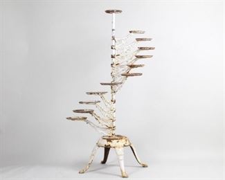 Lot 39: Victorian Multi Tier Rotating Cast Iron Plant Stand. An amazing plant stand in white painted cast iron. Eleven arms and one top plate to hold a total of twelve plants. A great piece for your plants at home or a flower shop.

Dimensions are 52.5 in h x 25 in w x 25 in d. Condition is fair to good. Substantial deterioration of paint, flaking and entirely absent is some spots. Heavy rust throughout. Legs slightly loose/wobbly. Please call or email for a detailed condition report.