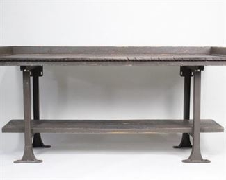 Lot 48: Industrial Wooden Work Shop Table Bench w/Metal Legs. A wood working table painted in a gray/green color with metal legs and storage shelf at bottom. Wood on underside is reads "Harco Alcoa  Tenn." In good condition to continue use as a working bench or as a desk.

Dimensions are 37.25 in h x 74.25 in w x 30.5 in d. Condition is good. Surface wear from years of use. Please call or email for a detailed condition report.