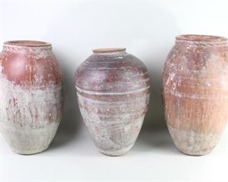 Lot 54: 3 Antique 19th C French Ship Ballast Pottery Urns. A lot of three French ballast pots from 19th century, or possibly earlier. Each pot is heavily weighted with very solid bottom. Two of the pots have a simple decor around the neck. Great patina on all three. Acquired in the 1980s, Haiti. From the collection of Barbara Porter & Robert Wincuinas.

Dimensions for the largest are 20 in h x 12 in w x 12 in d.
Dimensions for the smallest are 19 in h x 13 in w x 13 in d. Condition is good. Surface wear throughout. Some scratches, chipping and discoloration. Please call or email for a detailed condition report.