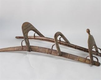 Lot 58: Antique 2 Passenger Camel Saddle Frame in Wood & Brass. An antique two person dromedary camel saddle. Frame made in wood with iron reinforcement and ornate brass detailing. Acquired in the 1980s, Connecticut. From the collection of Barbara Porter & Robert Wincuinas.

Dimensions are 14 in h x 51 in w x 21 in d. Condition is good. Overall surface wear. Rust to iron. Please call or email for a detailed condition report.