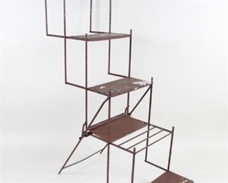 Lot 61: Industrial Folding 5-Tier Brown Metal Plant Stand Shelf. This folding display shelf is made of thin metal frame and solid sheet shelves painted in a dark brown color. Five increasingly recessed tiers allow sunlight and vertical space for many plants in a garden, patio, or other outdoor setting. Might also be used as an interesting vintage retail display that is portable for farmer's markets or fairs.

Dimensions are 53 in h x 18 in w x 39 in d. Folds to 44 in h x 3.5 in d. Condition is good, with cosmetic shipping and wear to paint that does not affect structural integrity. Please call or email for a detailed condition report.