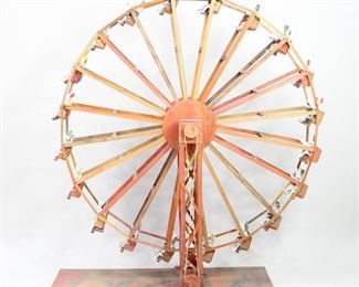 Lot 66: Delightful and giant Dia De Los Muertos Ferris Wheel with skeleton riders, many 2 to a seat.  Made of colorfully painted wood with a hand crank which cleverly turns the wheel and takes the happy skeletons for a ride. Acquired in Mexico. From the collection of Barbara Porter & Robert Wincuinas.

Dimensions are 66 in h x 21 in w x 59 in d. Condition is good with weathering from attic storage; a couple of skeletons have broken arms or legs. Please call or email for a detailed condition report.