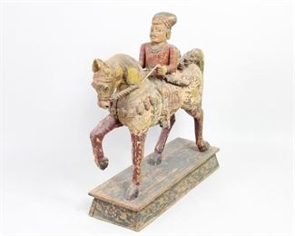 Lot 75: Antique Rajasthani India Folk Art Carved Horse & Rider. Beautifully detailed large hardwood carved & Temple Guardian horse with rider with polychrome decoration. Stands on a wooden base with polychrome floral decoration. Likely 19th century, acquired in India 1984. From the collection of Barbara Porter & Robert Wincuinas.

Dimensions are 36 in h x 37 in w x 11 in d. Condition is good. Please call or email for a detailed condition report.