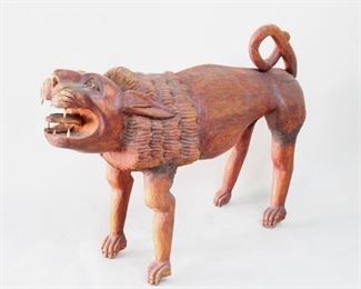 Lot 80: Large Haitian Carved Wood Lion Sculpture Statue (2/2). Wonderfully carved, stylized lion in red stained wood. Expressive face with fully carved out mouth and six teeth in contrasting wood. Acquired in the 1980’s, Haiti. This is the second out of two lots of similar lion sculptures. From the collection of Barbara Porter & Robert Wincuinas.

Dimensions are 32 in h x 15 in w x 46 in d. Condition is good. Surface wear throughout. Crack running through face and neck. Cracks where legs connect to body. Cracks towards back and on tail. Please call or email for a detailed condition report.