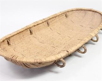 Lot 82: Woven Rattan Stretcher w/Handles,Ethiopian Folk Art. Beautifully handwoven stretcher is completely handcrafted from natural materials. Shallow and open ovoid basket has 8 handles. Acquired in Ethiopa in 1977. Could be used as a backdrop for sculpture, or perhaps even turn into a hammock. From the collection of Barbara Porter & Robert Wincuinas.

Dimensions are 32 in w x 72 in d. Condition is good. Please call or email for a detailed condition report.