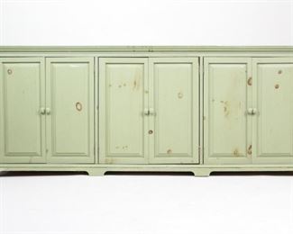 Lot 85: Country Farmhouse Green Sideboard Buffet Credenza. Large wooden sideboard, painted in a beautiful sage green, with ample of storage room. Three sections with two doors each and two shelves throughout. A perfect storage piece in a large kitchen, dining or living room.

Dimensions are 32.5 in h x 81 in w x 17.25 in d. Condition is good. Please call or email for a detailed condition report.
