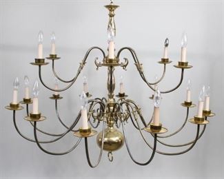 Lot 102: Large Brass 18 Arm Williamsburg Style Brass Chandelier. Spectacular hanging light fixture has 18 faux candle lights, arranged in 2 tiers. Perfect for the large dining room in your colonial style home. Ceiling mount and chain are disconnected. The lamp has not been tested for function, may need to be rewired.
Dimensions are 44 in h x 44 in w x 44 in d. Condition is good with some wear and discoloration throughout the metal. Please call or email for a detailed condition report.