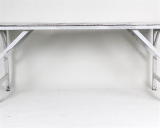 Lot 109: Collapsible Country Farmhouse White Wooden Work Table. This rustic work table is made of wood that has been painted white. It is easily collapsible by removing the bracing along the legs, making it extra handy for storage and transportation. Great for your next project.

Dimensions are 33 in h x 74 in w x 26 in d. Condition is fair. There are pronounced cuts and marks on the tabletop, especially in the center. There is extensive paint chipping, green paint marks underneath, and small splatter marks on the tabletop. Please call or email for a detailed condition report.