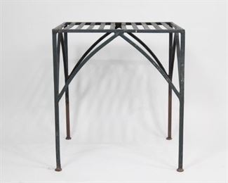 Lot 127: Wrought Iron Metal Garden Patio Side Table,Plant Stand. A sleek little side table in wrought iron with a slatted top. Gothic style arched leg supports. A great side table for a patio or next to a garden lounge chair.

Dimensions are 19.75 in h x 18 in w x 18 in d. Condition is good. Surface oxidation throughout, primarily on legs. Some spots on top.  Please call or email for a detailed condition report.