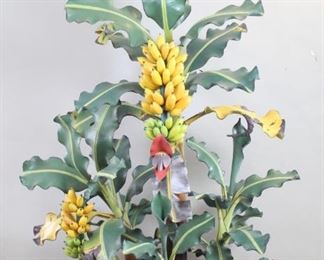 Lot 133: Large Wooden Indonesian Folk Art Banana Tree Sculpture. An incredibly detailed and life-like room size sculpture of a banana tree. Six main stalks make up the base, onto which each leaf is then assembled. It has two banana stalks with a flower and some leafs in more wilted stages which add to its realistic look. Hand carved and painted in excellent quality. Acquired in the 1980s, Indonesia. From the collection of Barbara Porter & Robert Wincuinas.

Dimensions are 76 in h x 54 in w x 41 in d. Condition is excellent. Minor surface wear, a couple of cracks in paint. The piece needs to be dissembled for shipping. Each pieces is marked and numbered. Please call or email for a detailed condition report.