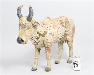 Lot 140: Lg India Folk Art Carved Sacred Cow Sculpture,Hinduism. Full of life and character, hand carved wooden cow has polychrome decoration with patina.  Acquired in India in 1985. Fabulous folk art to display as sculpture. From the collection of Barbara Porter & Robert Wincuinas.

Dimensions are 23 in h x 9 in w x 23 in d. Condition is good with wear and chipping to paint.. Please call or email for a detailed condition report.
