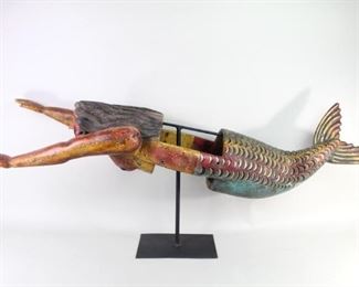 Lot 144: Carved Wood Mermaid Body Mask,Mexico Folk Art Sculpture. Mermaid body mask from Guerriro Mexico, used in the Danza de los Pescados (Fish Dance). Gorgeous mermaid is carved from wood with rich polychrome decoration, and an opening in the center for wearing as a mask. Mounted on a black metal stand for display. Acquired in 1986 in Mexico. From the collection of Barbara Porter & Robert Wincuinas.

Dimensions are 22 in h x 17 in w x 55 in d. Condition is good with wear to the paint and patina. Please call or email for a detailed condition report.