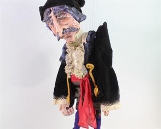 Lot 147: Ship's Captain Puppet Marionette Marjorie Moore (2/2). Fantastic marionette of a pirate by Maine artist Marjorie Moore (b. 1944). Papier mache head, hands and feet. Wood structured and stuffed body. Wonderfully detailed and hand made clothing. Made in 1973. This is the second of two lots of marionettes by Moore. From the collection of Barbara Porter & Robert Wincuinas.

Dimensions are 35 in h x 9 in w x 6 in d. Condition is good. Some surface wear throughout. Minor dust. Please call or email for a detailed condition report.