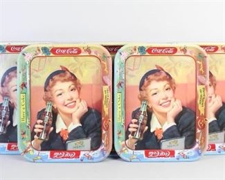 Lot 172: Lot of 5 1953 Coca Cola Menu Girl Metal Serving Trays and 2 Signs. Identical full color trays feature a smiling coke-drinking young woman, with a border of seasonal images and "Thirst Knows No Season". Wonderful matching set for mid-century entertaining. In addition there are 2 side hung Coca Cola signs.
Dimensions of the trays are 1 in h x 10.5 in w x 13.25 in d. Condition of the trays is good with surface wear, primarily to the edges, worn spots and minor rust. Dimensions of the signs are 20.5 in h x 24 in w x 3 in d. The signs are in fair condition with rust and peeling paint. Please call or email for a detailed condition report.