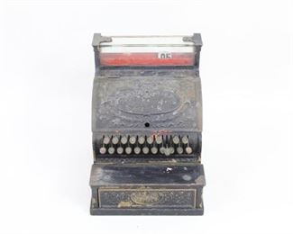 Lot 179: Antique Cast Bronze National Cash Register. An antique cash register from the "National Cash Register Co." Made in cast metal, possibly bronze, and painted black with beautiful cast Fleur-de-lis motifs and floral patterns throughout. The drawer is made in wood. Still functions, with lock included but disconnected.

Dimensions are 17 in h x 13.5 in w x 15.5 in d. Condition is good. Surface wear and paint chipping throughout. No key for lock. Please call or email for a detailed condition report.
