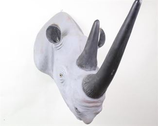 Lot 186: Life Size Faux Taxidermy 2 Horned Rhino Head Wall Mount. Huge faux rhino head is molded from a composite material and painted, and has glass eyes. A metal fastener is attached to the top for hanging on a wall.
Dimensions are 41 in h x 25 in w x 55 in d. Condition is good with wear to the paint, and some red paint worn onto the face. Please call or email for a detailed condition report.