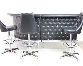 Lot 237: Mid-Century Tufted Black Chrome Modular Bar & 3 Stools. This complete bar set has a two bar sections, one straight and one with a 90-degree curve, which can be configured to fit in any part of a room. Lusciously upholstered in leather-like material tufted with metal buttons in an argyle or diamond pattern, with bar front and padded elbow rests to match the three high-backed cushioned stools. Rotating stools have footrests in addition to integrated bar-front rest, all in shiny tubular chrome. Bar has one shelf dividing upper and lower sections. Wood veneer details throughout. 

Dimensions of straight bar section are 43 in h x 41 in w x 20 in d. Curved section is 43 in h x 53.5 in w x 20 in d. Stools are 45 in h x 24.5 in w x 24.5 in d, with a seat height of 29.75 inches. Condition is good, with some scratches and wear consistent with age, and minimal water damage. Some tears have been repaired with what appears to be electrical tape. Please call or email for a detailed conditio