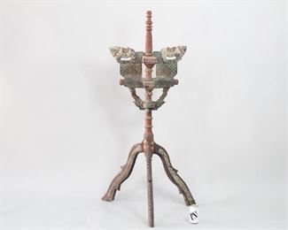 Lot 249: Large Carved Wooden Incense Burner Stand from India. Possibly an incense burner stand in carved and painted wood. Red painted column in turned wood on an base with three arched legs. The extensively carved upper portion has two holders, placed directly on top on one another. The full top section can be turned around without moving the whole stand. Acquired in the 1980s, India. From the collection of Barbara Porter & Robert Wincuinas.

Dimensions are 56 in h x 27 in w x 27 in d. Condition is good. Surface wear, discoloration and a small cracks throughout. Please call or email for a detailed condition report. 