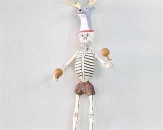 Lot 250: Day of Dead Dancing Deer Skeleton,Mexican Folk Art 1/2. Large Día de los Muertos Dancing Skeleton is wearing a helmet mask with an antlered deer head, and is holding maracas. Fanciful and fun figure is made of carved wood with painted polychrome decoration. There is another similar skeleton listed separately. Acquired in Veracruz, Mexico in 1986. From the collection of Barbara Porter & Robert Wincuinas.

Dimensions are 58 in h x 20 in w x 16 in d. Condition is good. Please call or email for a detailed condition report.
