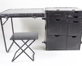Lot 253: Vintage Military Style Portable Field Desk Trunk w Seat. Design resembles field desks used by the US during the WWII era, though this piece was painted black long enough ago to acquire a nice patina of scratches and scuffs. Metal corner braces recall the once-ubiquitous steamer trunks of an earlier era. Includes matching black painted seat. Work from home, or anywhere, with this stylish desk in a trunk.

Dimensions of chest when collapsed are 17.5 in h x 27 in w x 23.75 in d. Seat is 14 in h x 14.75 in w x 11.5 in d. Condition is fair, with lots of scratches and scuffs to paint and slight oxidation to metal. Please call or email for a detailed condition report.