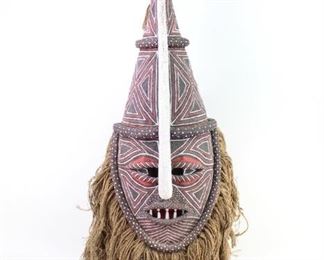 Lot 263: Tribal Makishi Chokwe Cikunza Male Initiation Mask. A Makishi, a male initiation mask of the Chokwe people in Congo, Zambia. Represents the spirit Cikunza and used in initiation ceremonies. Painted burlap type cloth with fringe attached all around. Mounted on a stand. Acquired in the 1970s. From the collection of Barbara Porter & Robert Wincuinas.

Dimensions (with stand) are 40 in h x 14 in w x 14 in d. Condition is good to very good. Please call or email for a detailed condition report.
