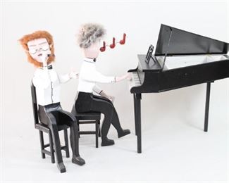 Lot 266: Carved Wood American Folk Art Sculpture,Musicians. Delightful pair of musicians are made of wood and faux fur with vibrant polychrome decoration. Gray haired pianist with musical notes flowing from his mouth and red haired flute/recorder player enthusiastically play a duet at a baby grand piano in this unusual sculpture. Self-portrait by the artist; he is on the recorder with his friend on piano as they play Baroque music. Created in the early 1980's by New England outsider artist Robert Wincuinas.
Dimensions are 38 in h x 24 in w x 33 in d for the piano and 39 in h x 7 in w x 17 in d for the musicians. Condition is good with a broken and repaired arm and a crack down the side of the flute player and minor surface wear, a couple of small paint loss spots, some discoloration. Please call or email for a detailed condition report.