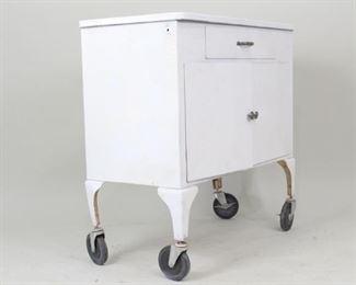 Lot 336: White Shampaine Industrial Medical Cabinet Rolling Cart. Wonderful cart is made of white enameled metal, has a drawer and 2 doors which open to reveal 2 shelves. "Shampaine Company/St. Louis USA" label inside the right door. Four wheels make the cabinet portable. Useful storage for your studio or workshop.
Dimensions are 36 in h x 36 in w x 18.5 in d. Condition is fair with wear to paint & metal and scratches. Please call or email for a detailed condition report.