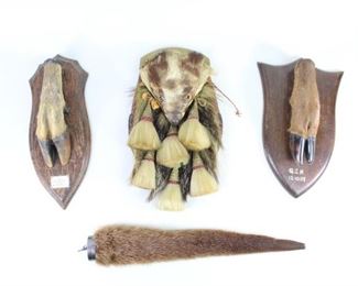 Lot 391: Scottish Full Badger Sporran,2 Stag Hooves & Otter Tail. Spectacular lot includes an antique Full Badger Head Sporran with 6 metal and animal hair tassels, a type used by officers in both the Argyll & Sutherlands and the Calgary Highlander Regiments. Pouch has a red leather back and the metal tops of the tassels are decorated with thistles. Lot also includes a stuffed otter tail with a silver metal cap with stamped hallmarks, and 2 English stag hooves, mounted on wood plaques. One is poignantly marked "Major's Last Hunt".

Dimensions range from 12 in h x 7.5 in w x 3.25 in d for one of the hooves to 17 in h x 3.5 in w x 2 in d for the tail.. Condition is very good with minor surface wear, and waer to the badger's face. Please call or email for a detailed condition report.
