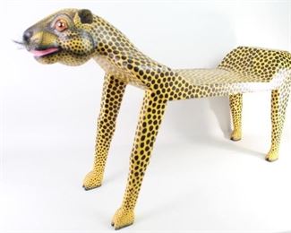 Lot 396: Indonesia Folk Art Carved & Painted Wood Cheetah Bench. Fantastic sculptural bench is carved from wood and painted in yellow & black. Face is expressive and detailed with whiskers. Acquired in Indonesia,1993. From the collection of Barbara Porter & Robert Wincuinas.

Dimensions are 25 in h x 40 in w x 11 in d. Condition is good with some paint flaking which has been touched up. Please call or email for a detailed condition report.